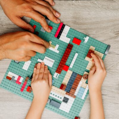 father-daughter-playing-with-legos-light-wooden
